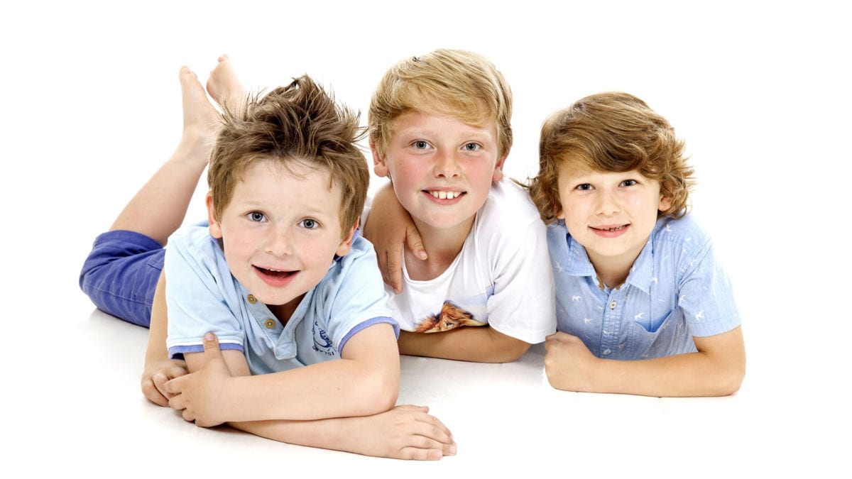 Portrait photograph of three boys in studio