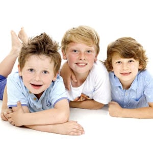 Portrait photograph of three boys in studio
